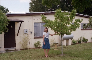 Karen in backyard with birdbath & trees; Orlando, Florida